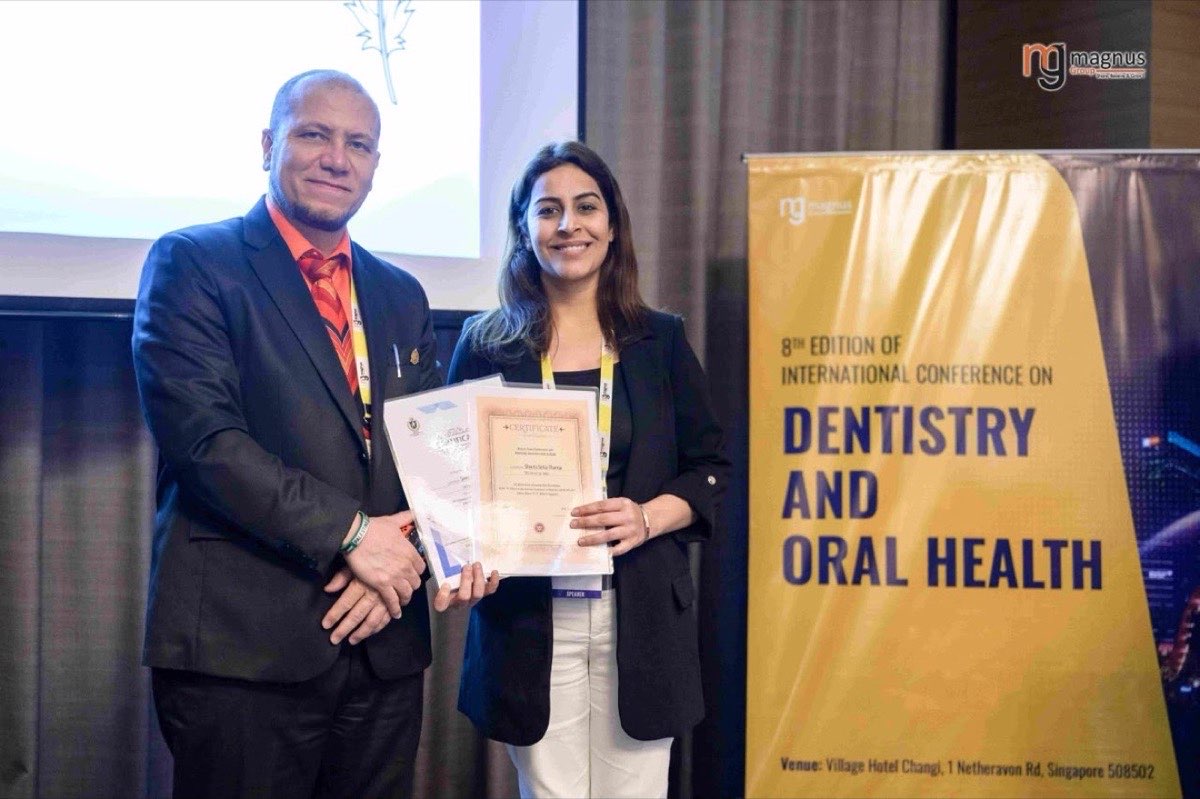 Dr Shveta Setia Thareja receiving a certificate of recognition at the International Conference on Dentistry and Oral Health, Singapore
