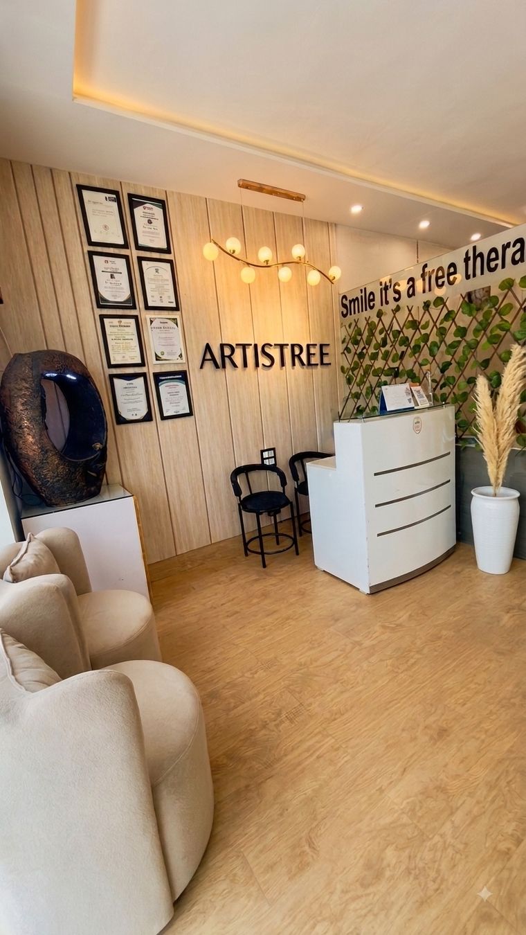 The Artistree reception desk beneath the clinic name and the doctor's framed certificates