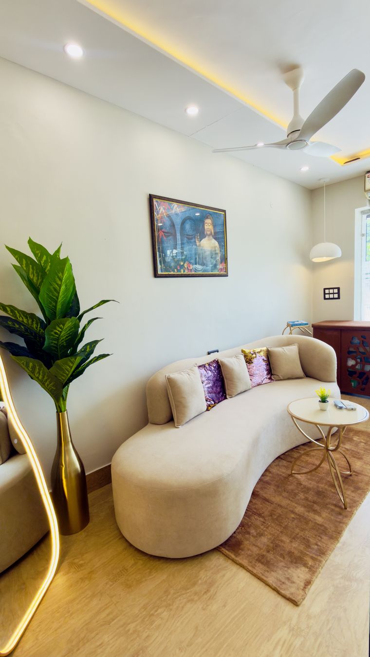 The waiting lounge at Artistree Dental with a curved sofa and rug