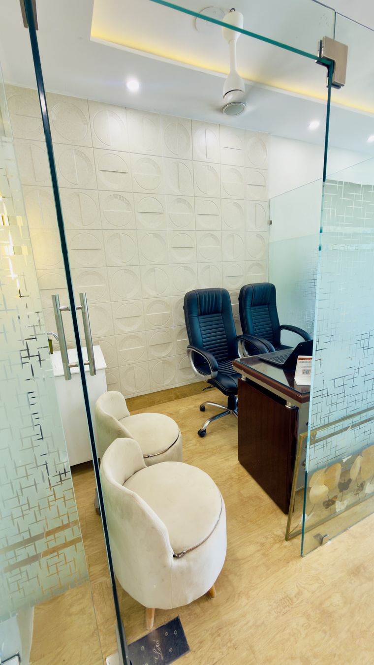 The consultation cabin at Artistree Dental, seen through its glass door